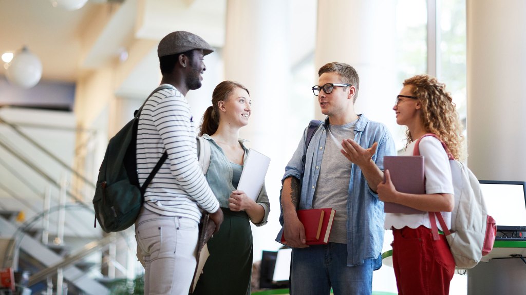 4 college kids speaking in a group